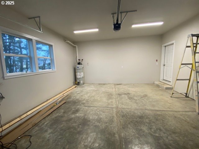 garage with a garage door opener and strapped water heater