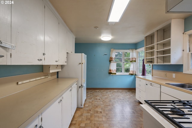 kitchen featuring white cabinetry, white appliances, and sink