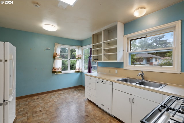 kitchen featuring white cabinets, white appliances, and sink