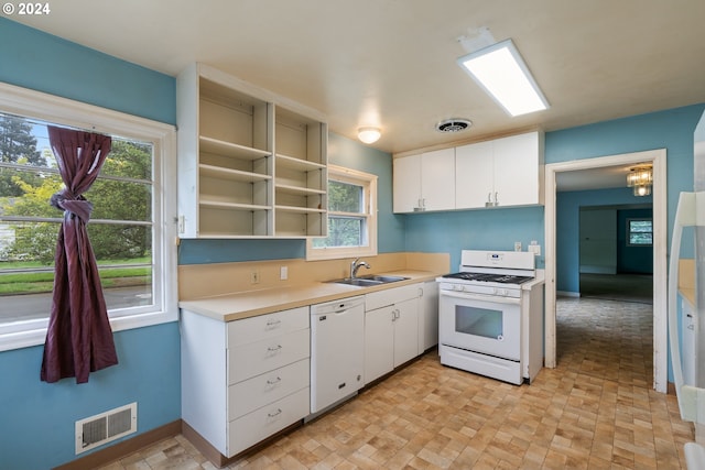 kitchen featuring white cabinets, white appliances, and sink