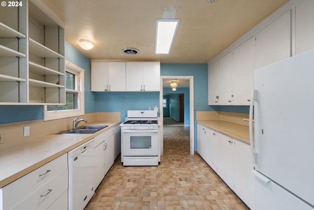 kitchen featuring sink, white cabinets, and white appliances