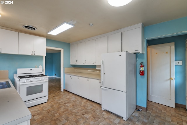 kitchen featuring white appliances, white cabinetry, and sink