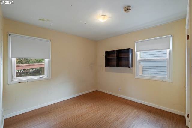 spare room with light hardwood / wood-style flooring