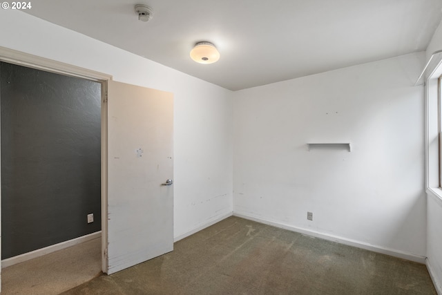 unfurnished room featuring carpet flooring