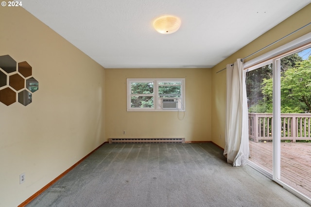 carpeted spare room featuring a baseboard radiator, plenty of natural light, and cooling unit