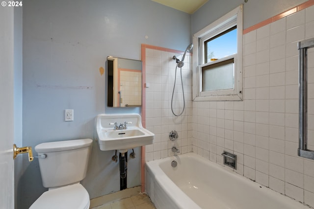 bathroom with tile patterned floors, tiled shower / bath combo, and toilet