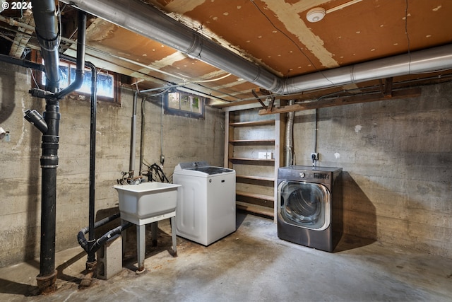 basement with washer and clothes dryer and sink