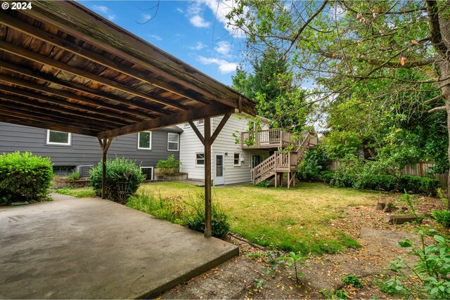 view of yard featuring a patio and a deck