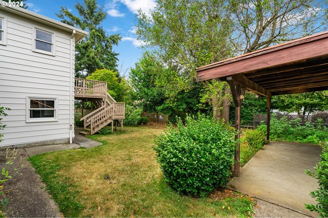 view of yard with a patio and a wooden deck