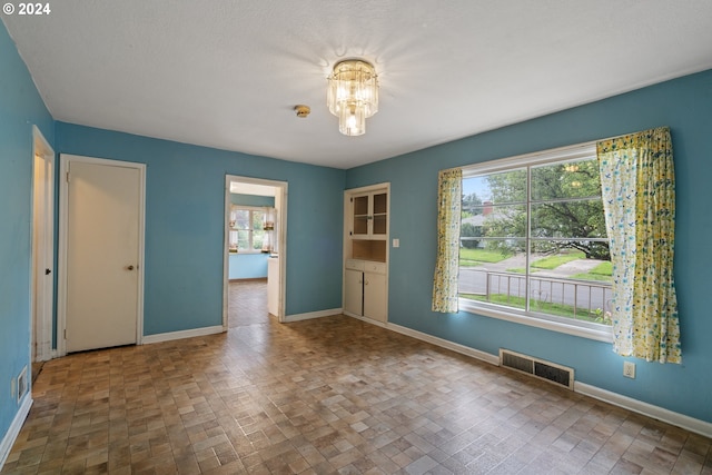 empty room with a notable chandelier