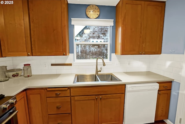 kitchen with dishwasher, electric range, tasteful backsplash, and sink