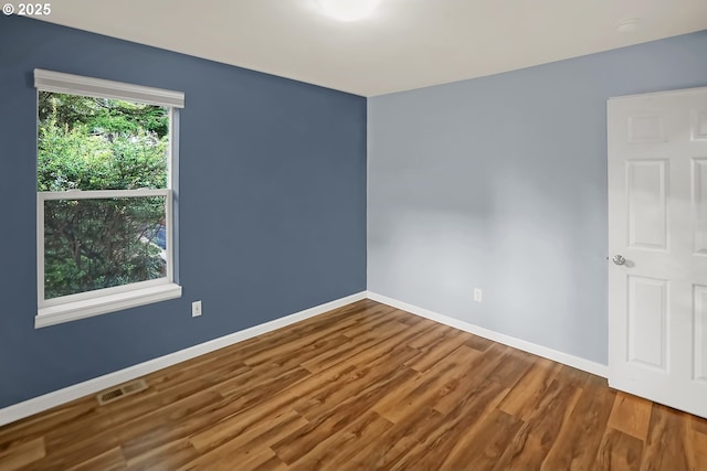 unfurnished room with wood-type flooring