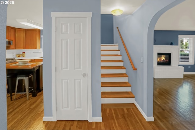 stairs featuring hardwood / wood-style floors