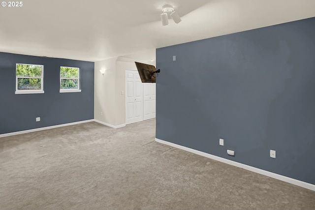 spare room featuring carpet floors and ceiling fan