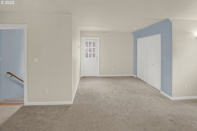 unfurnished room featuring light carpet