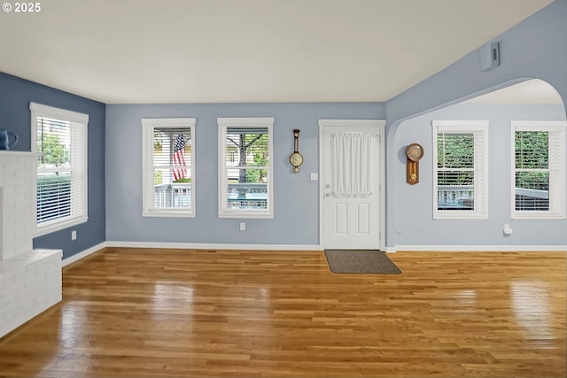 foyer featuring light hardwood / wood-style floors and a fireplace