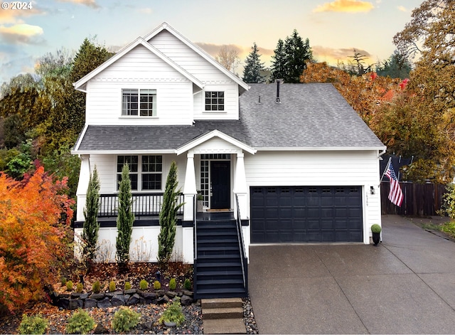 view of front of house featuring a porch and a garage