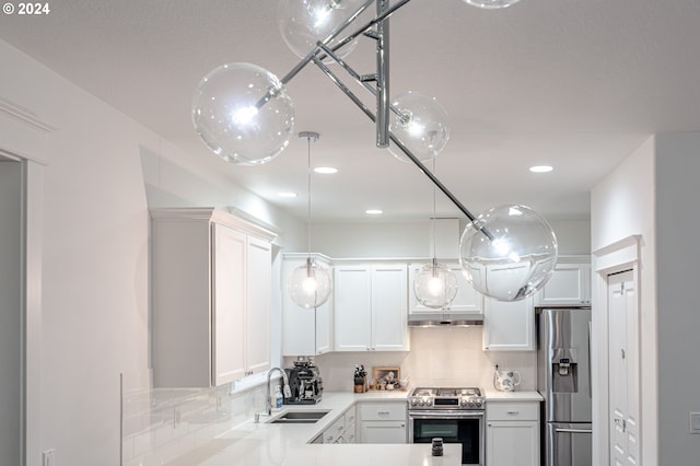 kitchen featuring white cabinets, stainless steel appliances, tasteful backsplash, and sink