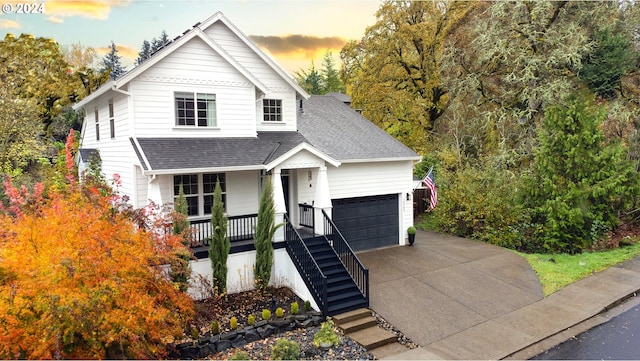 view of front of property featuring a garage and covered porch