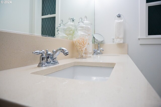 interior details featuring decorative backsplash and vanity