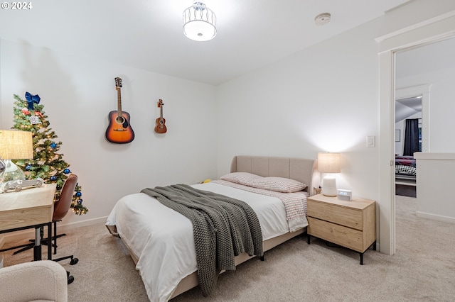 bedroom featuring light colored carpet