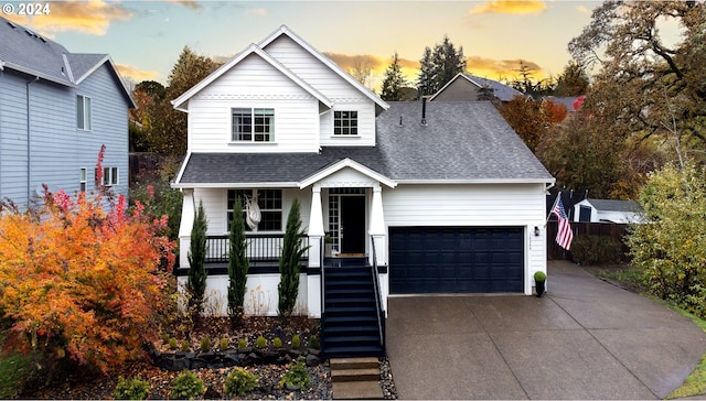 view of front of property with covered porch and a garage