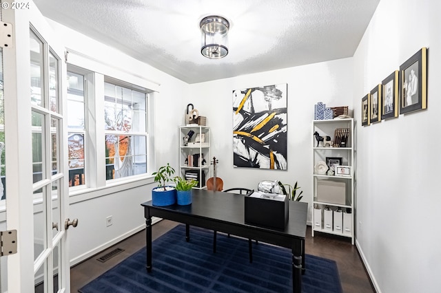 office featuring dark hardwood / wood-style flooring and a textured ceiling