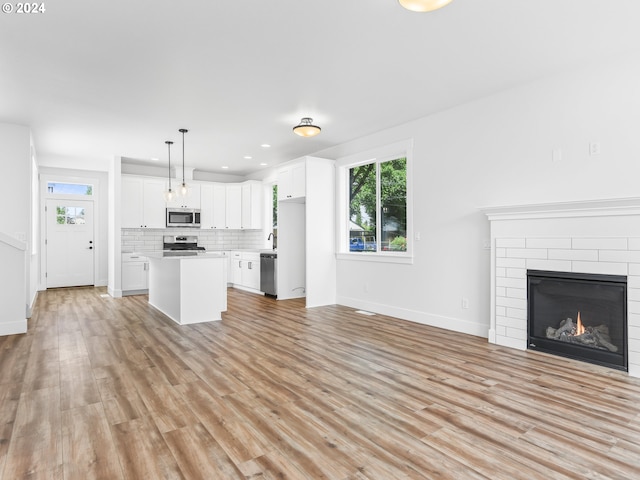 unfurnished living room with light wood-type flooring