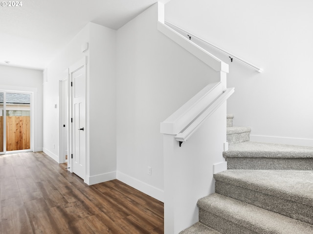 stairs featuring wood-type flooring