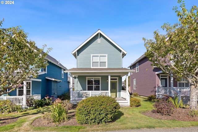 traditional-style home with a front lawn and covered porch