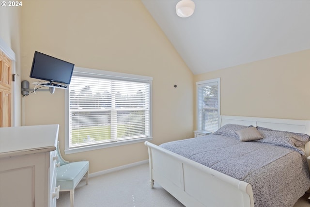 bedroom featuring light carpet and high vaulted ceiling