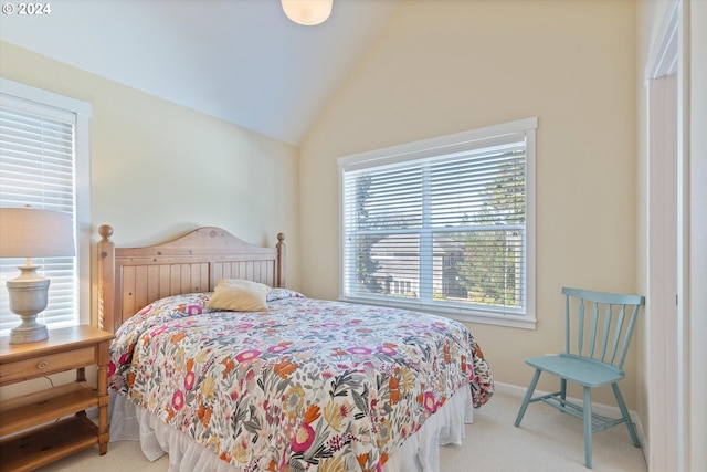 carpeted bedroom with high vaulted ceiling