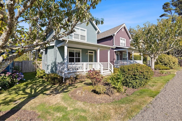 view of front of house with a porch and a front lawn