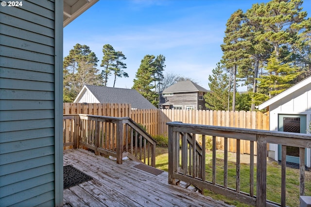 wooden terrace with a lawn