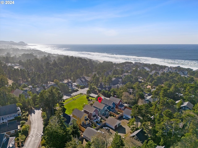 birds eye view of property featuring a water view and a beach view