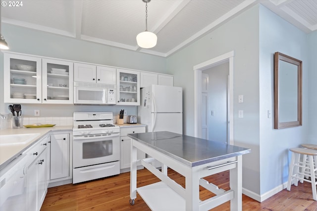 kitchen with white appliances, sink, white cabinetry, pendant lighting, and light hardwood / wood-style flooring