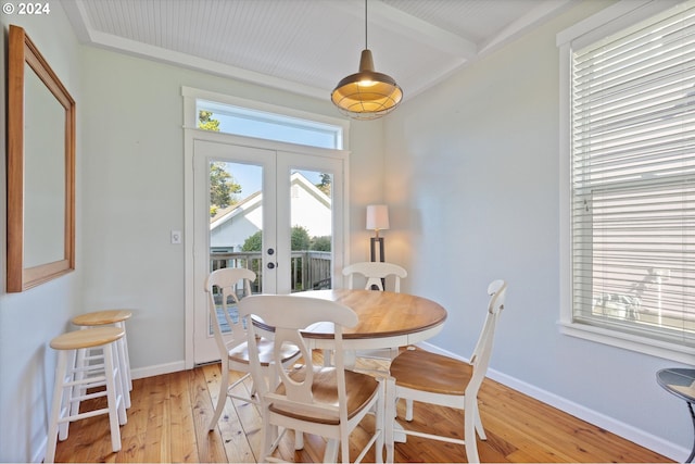 dining area featuring light hardwood / wood-style flooring, french doors, and beam ceiling