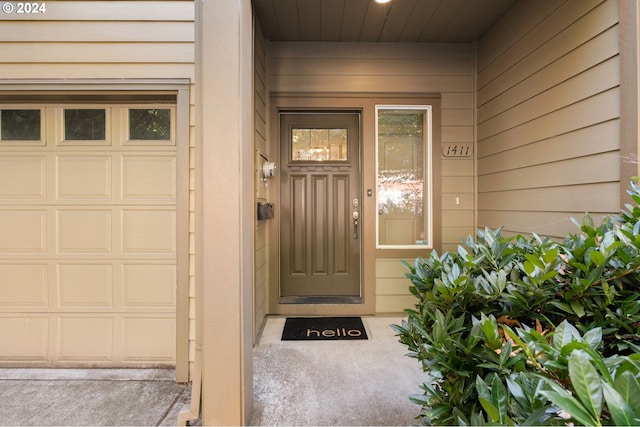 view of exterior entry with a garage