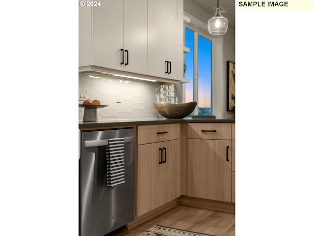 kitchen featuring decorative light fixtures, light brown cabinetry, hardwood / wood-style floors, white cabinets, and stainless steel dishwasher