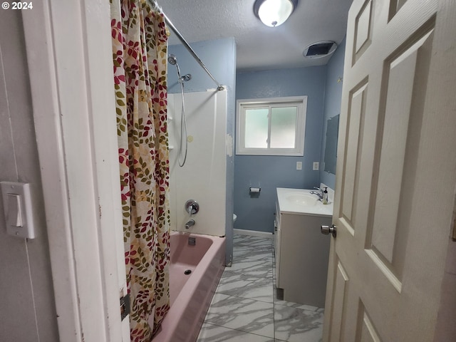 bathroom featuring vanity, shower / tub combo with curtain, and a textured ceiling