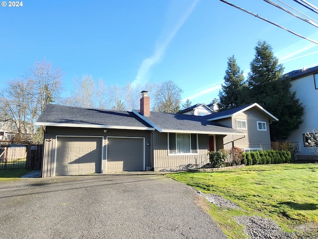 view of front facade featuring a front lawn and a garage