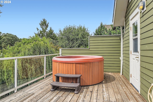 wooden terrace with a hot tub