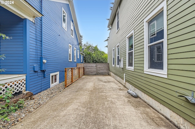 view of property exterior featuring fence and a patio