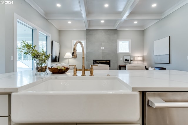 interior space with light stone countertops, sink, and a wealth of natural light