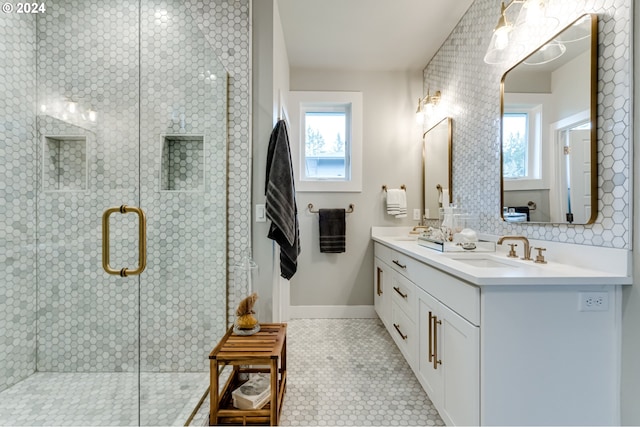 bathroom with walk in shower, vanity, and tile patterned floors