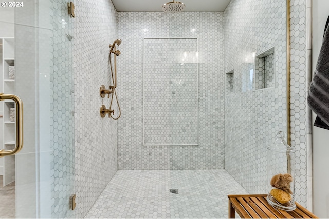 bathroom featuring a shower with door