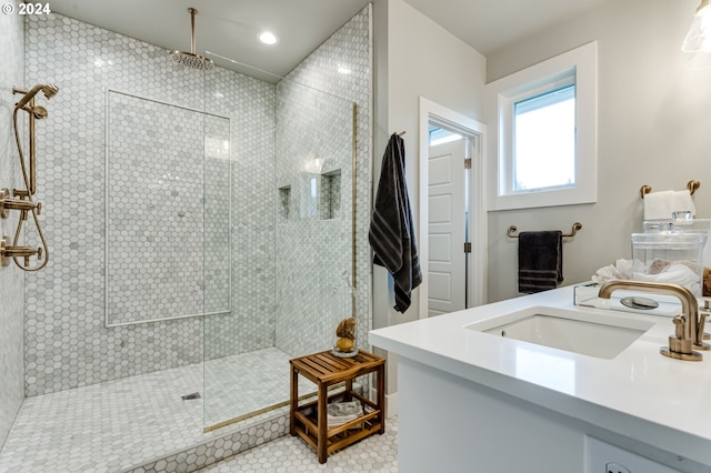 bathroom with a shower with door, vanity, and tile patterned floors