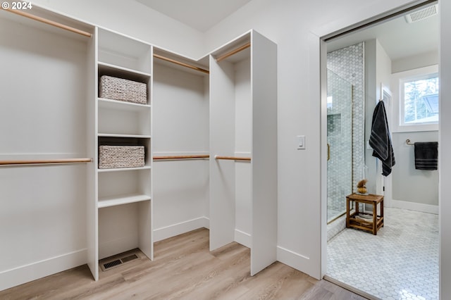 walk in closet featuring light wood-type flooring