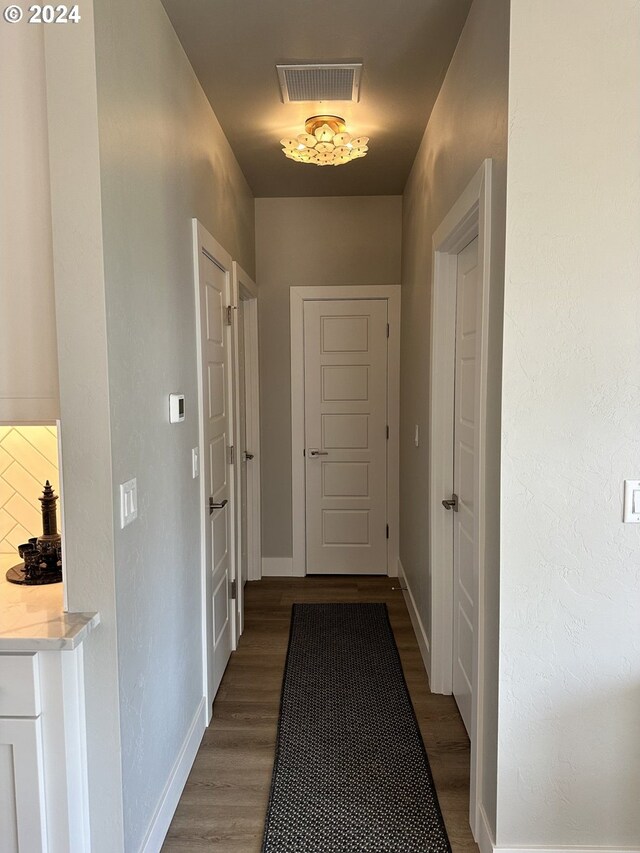 hallway with dark hardwood / wood-style flooring