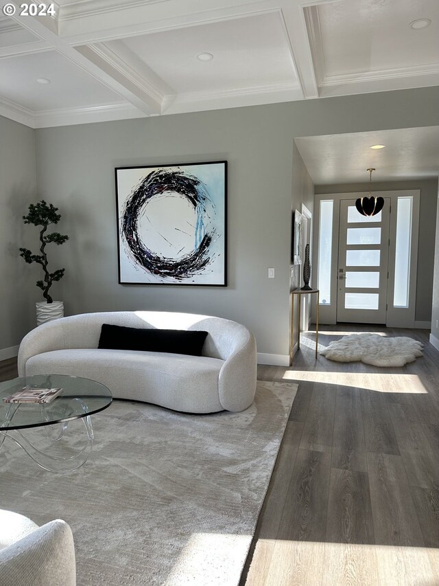 living room with ornamental molding, wood-type flooring, beamed ceiling, and coffered ceiling